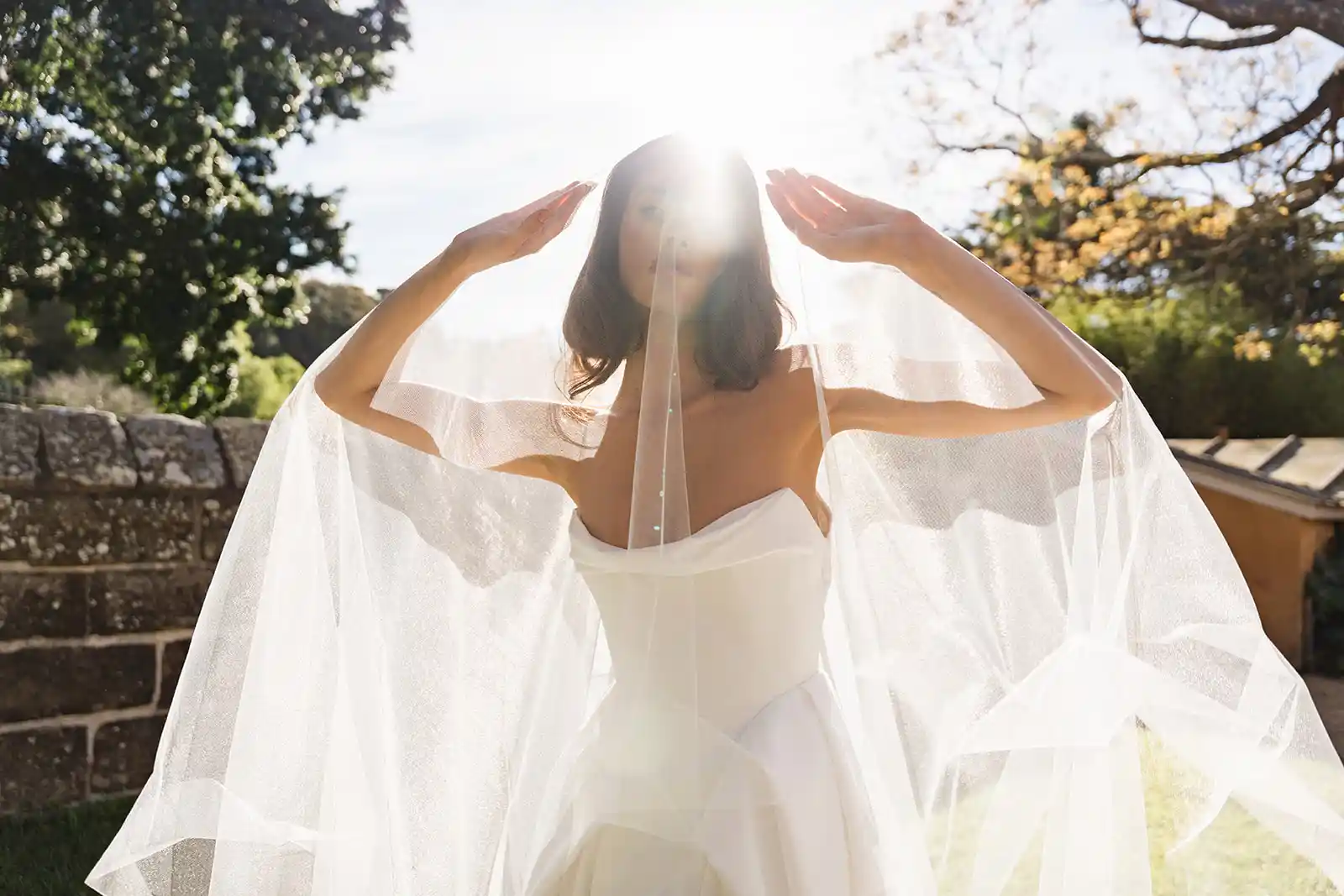 Satin ballgown and tulle veil by Moira Hughes for modern brides